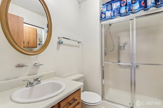 bathroom with vanity, toilet, and walk in shower