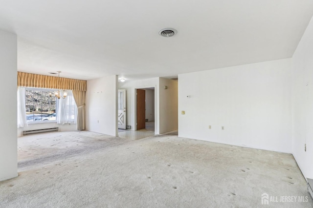 carpeted spare room featuring an inviting chandelier and a baseboard radiator