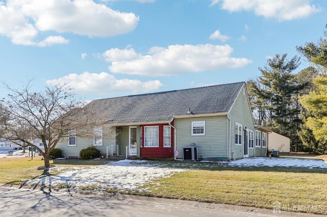 single story home with a front yard and central AC unit