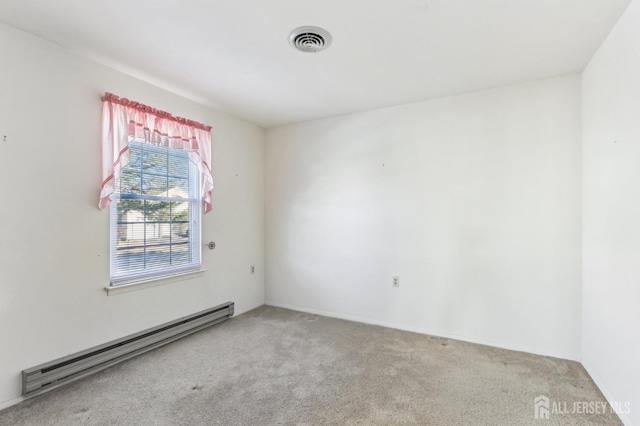 carpeted empty room with a baseboard heating unit