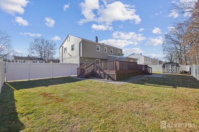 view of yard with a wooden deck and a storage unit