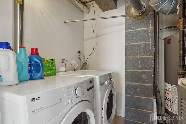 laundry room featuring washing machine and dryer and gas water heater