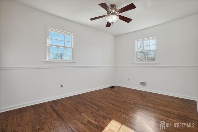 unfurnished room with ceiling fan and dark wood-type flooring