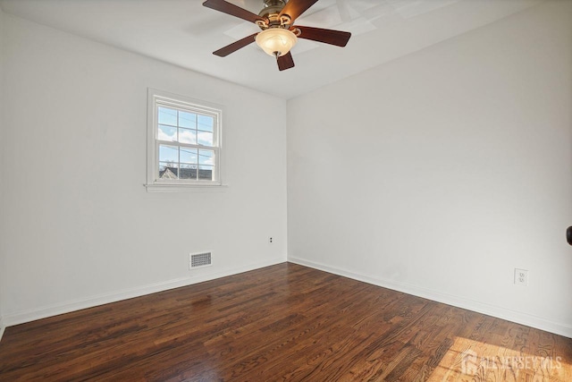 empty room featuring ceiling fan and dark hardwood / wood-style floors