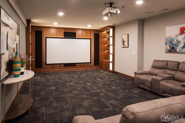 carpeted cinema featuring wooden walls