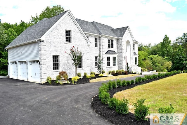 view of front of property featuring a garage and a front lawn