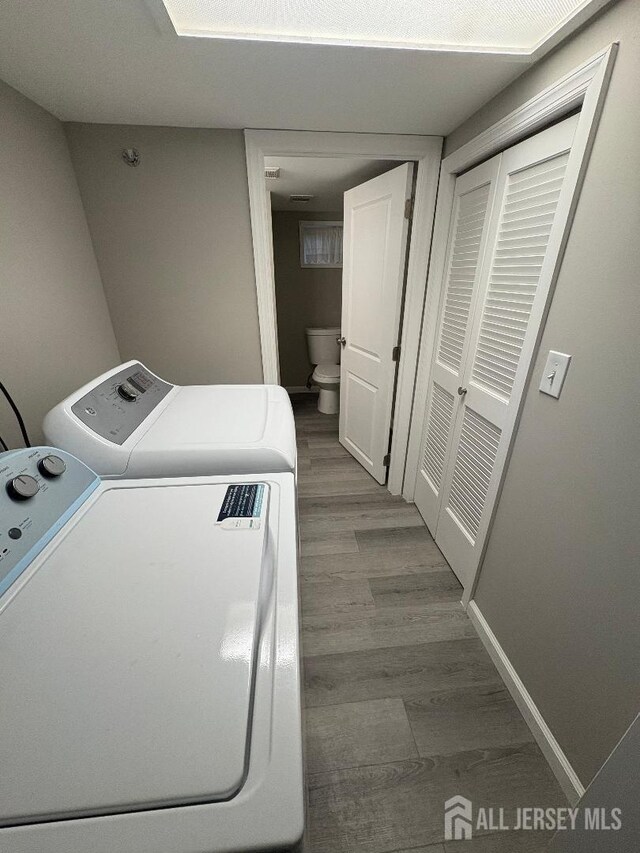 28 Maplewood Ave, Colonia, NJ 07067 - washroom with washer and dryer and wood finished floors