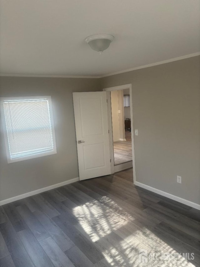 28 Maplewood Ave, Colonia, NJ 07067 - unfurnished room with ornamental molding, dark wood-style floors, and baseboards