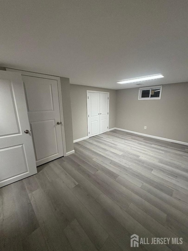 unfurnished bedroom featuring baseboards and wood finished floors