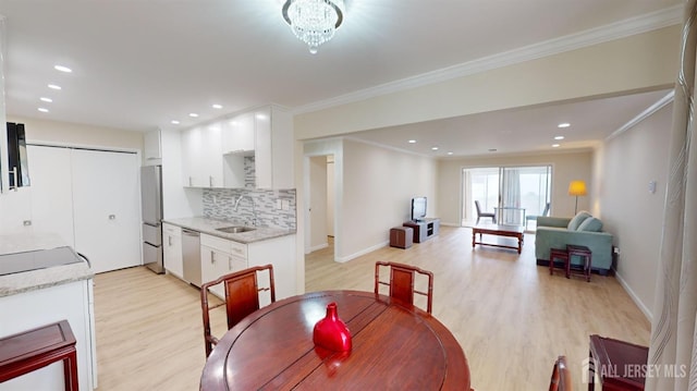 dining room featuring recessed lighting, ornamental molding, light wood finished floors, and baseboards