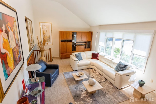 carpeted living room featuring high vaulted ceiling