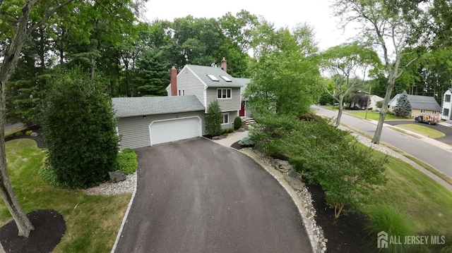 view of front facade with a front yard and a garage