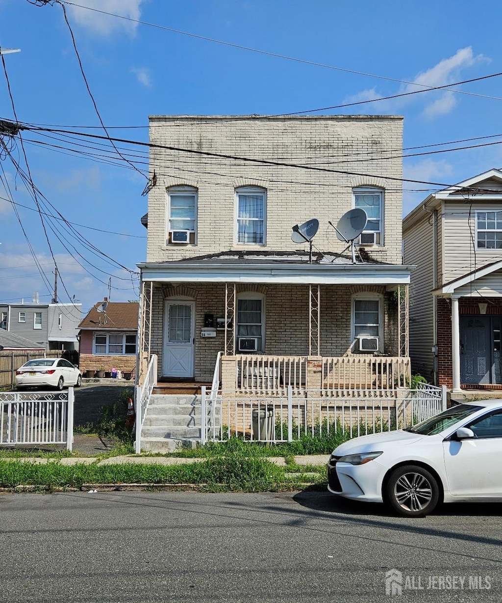 view of front of house with a porch and cooling unit