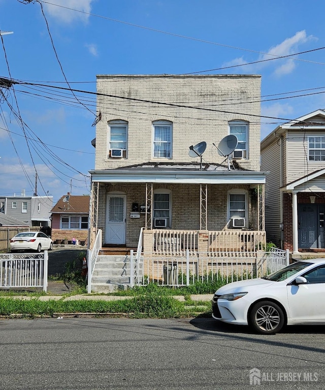 view of front of house with a porch and cooling unit