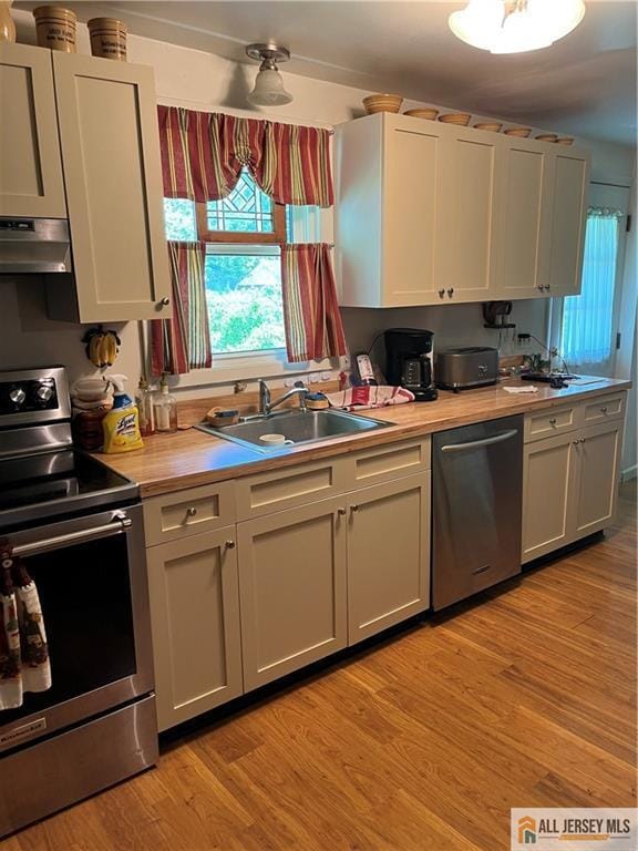 107 Readington Rd, Readington, NJ 08889 - kitchen featuring appliances with stainless steel finishes, ventilation hood, light countertops, and healthy amount of natural light