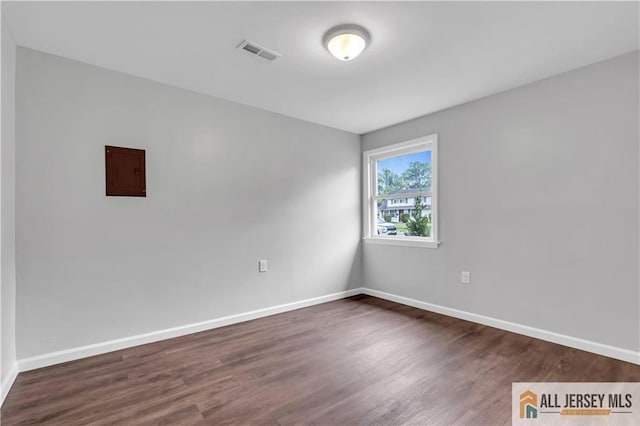 1092 Woodruff St, Iselin, NJ 08830 - spare room featuring dark wood-type flooring, baseboards, and electric panel