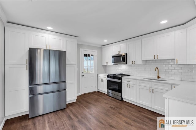 1092 Woodruff St, Iselin, NJ 08830 - kitchen with appliances with stainless steel finishes, a sink, backsplash, dark wood-style floors, and recessed lighting