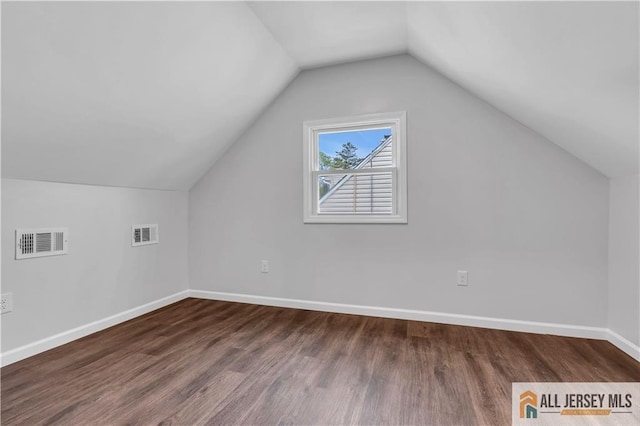 1092 Woodruff St, Iselin, NJ 08830 - bonus room featuring wood finished floors, lofted ceiling, and baseboards