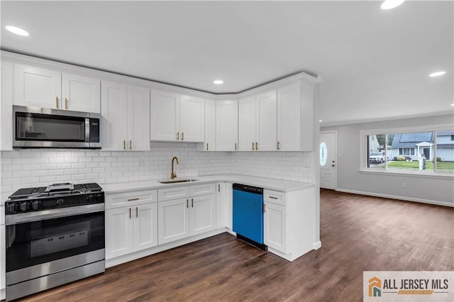 1092 Woodruff St, Iselin, NJ 08830 - kitchen featuring stainless steel appliances, a sink, light countertops, white cabinetry, and dark wood-style floors