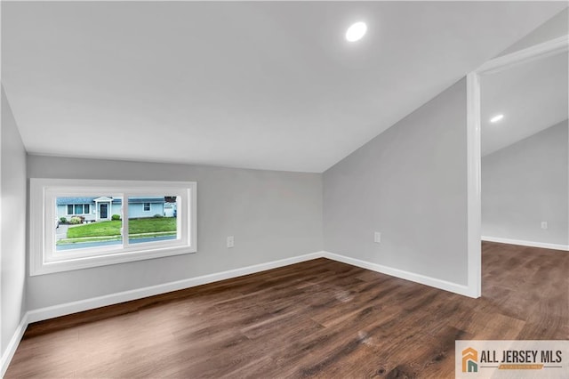 1092 Woodruff St, Iselin, NJ 08830 - bonus room featuring lofted ceiling, dark wood-style flooring, and baseboards