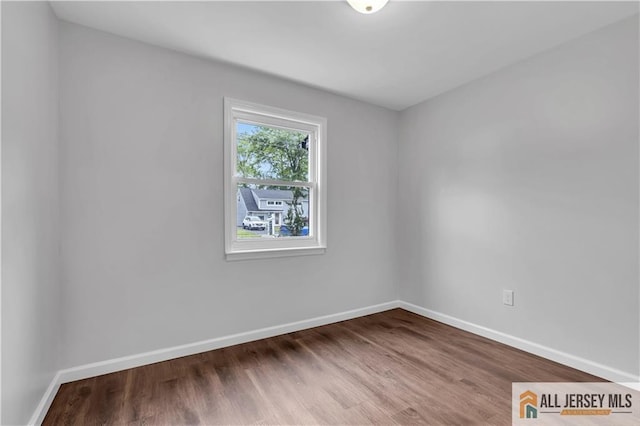 1092 Woodruff St, Iselin, NJ 08830 - unfurnished room with baseboards and wood finished floors