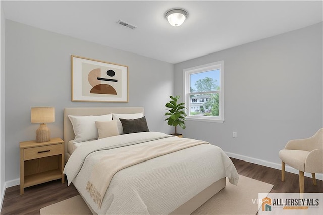 1092 Woodruff St, Iselin, NJ 08830 - bedroom featuring dark wood-style flooring and baseboards