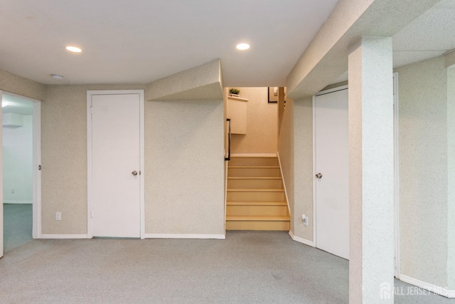 finished below grade area with recessed lighting, baseboards, stairs, and carpet