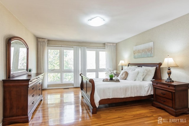 bedroom featuring visible vents and light wood-style floors