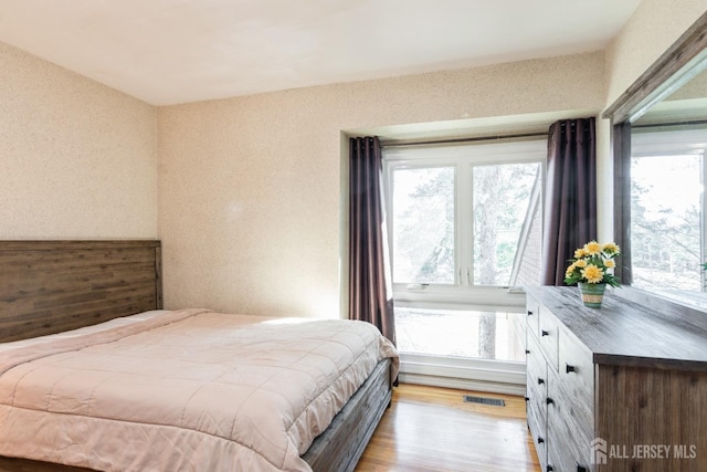 bedroom featuring visible vents and light wood finished floors