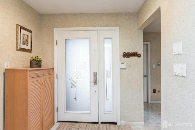 foyer entrance featuring light tile patterned floors