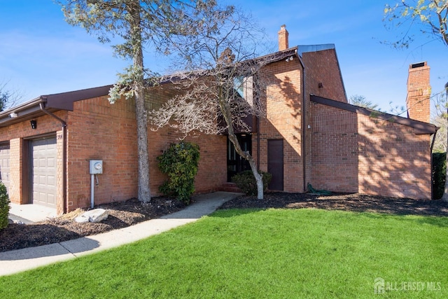 view of side of property featuring a garage, a lawn, brick siding, and a chimney