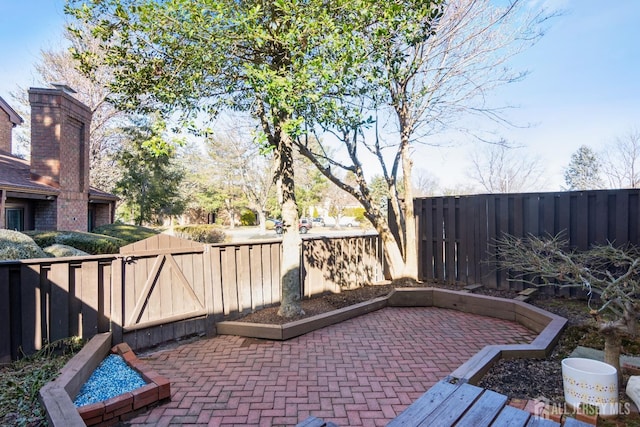 view of patio / terrace with a fenced backyard and a gate