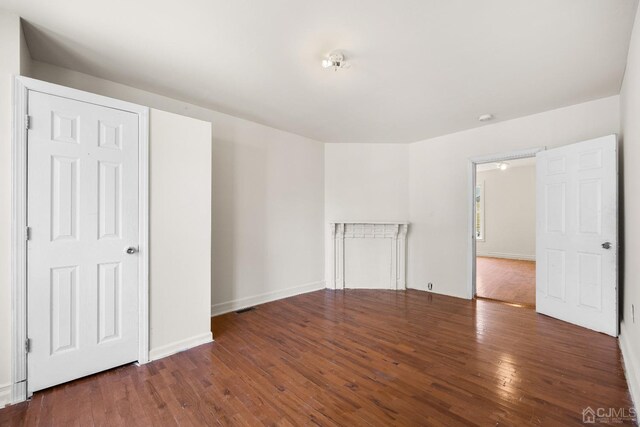 empty room featuring dark hardwood / wood-style flooring