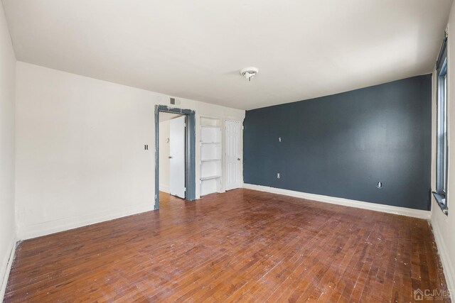 spare room with hardwood / wood-style flooring