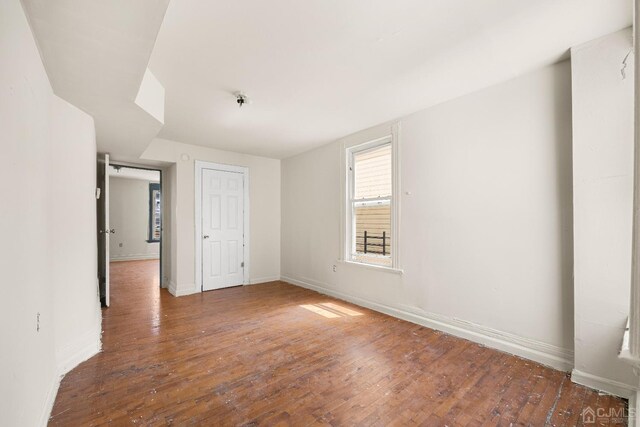 unfurnished bedroom featuring dark hardwood / wood-style floors