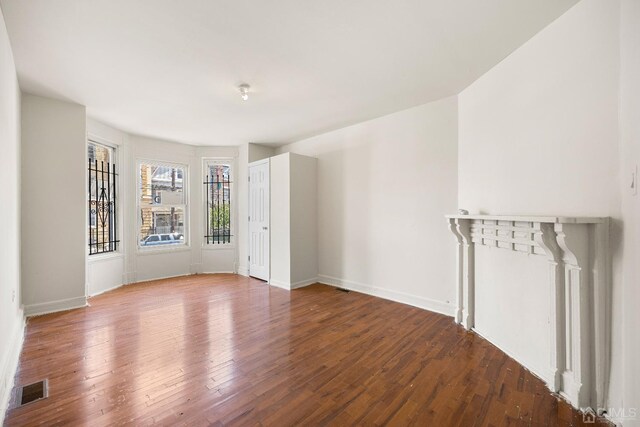 spare room featuring wood-type flooring