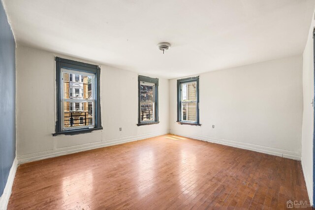 spare room featuring hardwood / wood-style floors