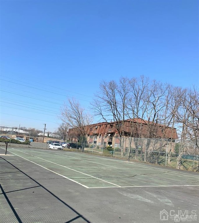 view of sport court featuring fence