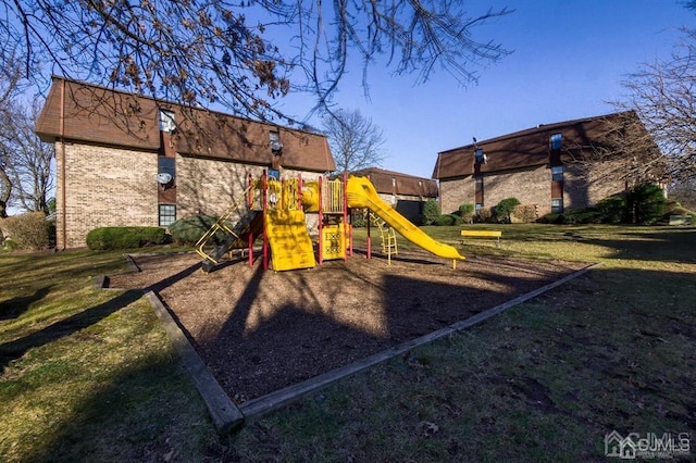 community jungle gym featuring a lawn