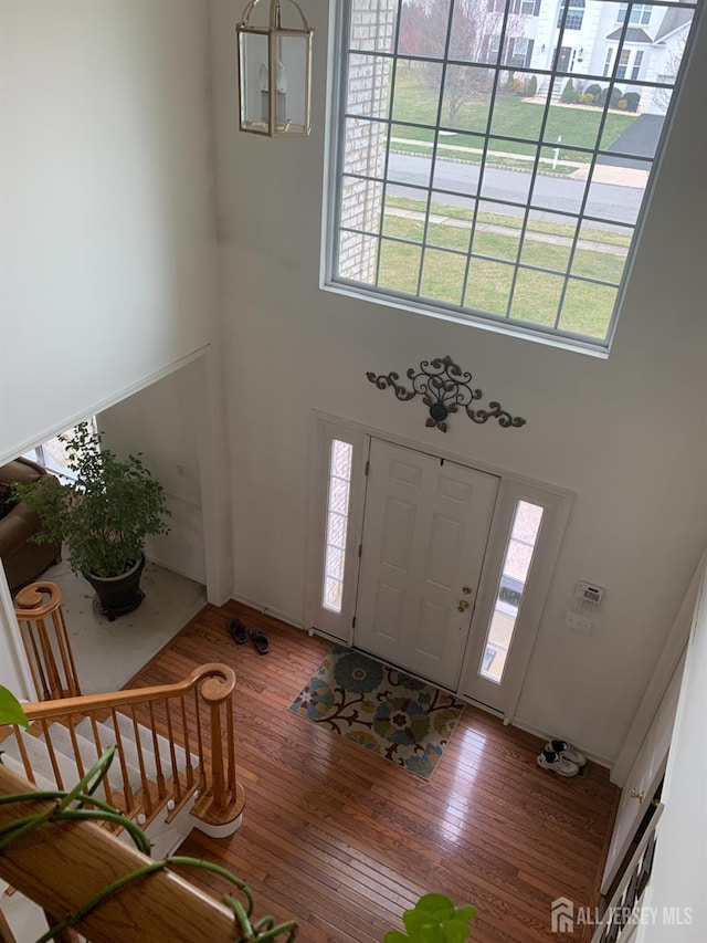 54 Mcfarlane Cir, Monroe, NJ 08831 - foyer with wood-type flooring, a towering ceiling, and a healthy amount of sunlight