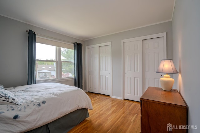 5 Wetherhill Way S, Brunswick, NJ 08810 - bedroom featuring ornamental molding, two closets, light wood-type flooring, and baseboards