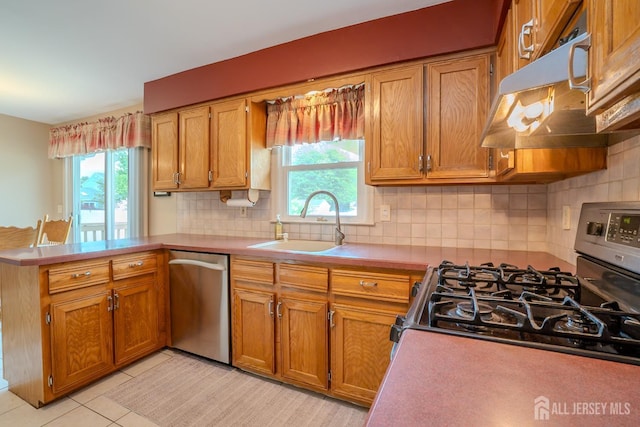 5 Wetherhill Way S, Brunswick, NJ 08810 - kitchen featuring appliances with stainless steel finishes, a peninsula, under cabinet range hood, a sink, and healthy amount of natural light