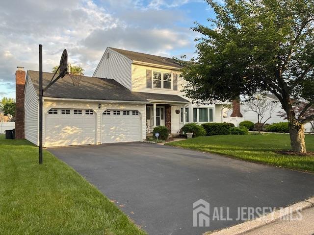 5 Wetherhill Way S, Brunswick, NJ 08810 - traditional-style home featuring a garage, driveway, and a front lawn