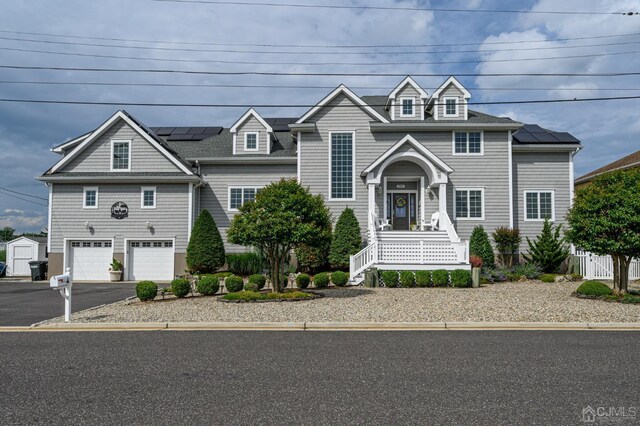 view of front of home featuring a garage and solar panels