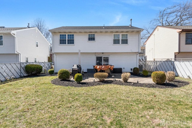 back of property with fence and a yard