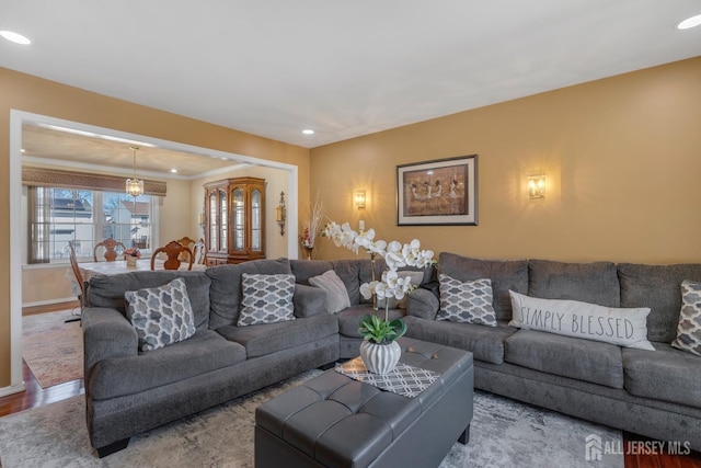 living area with wood finished floors, recessed lighting, and baseboards