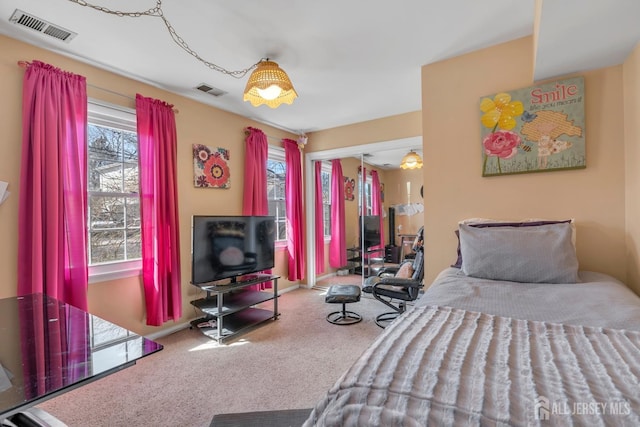 carpeted bedroom with visible vents