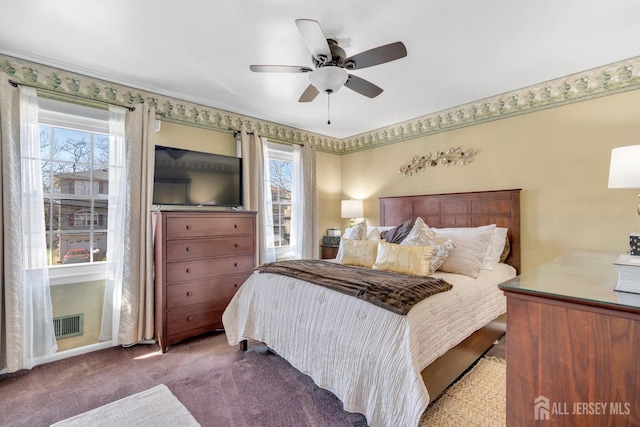 bedroom with visible vents, ceiling fan, multiple windows, and carpet