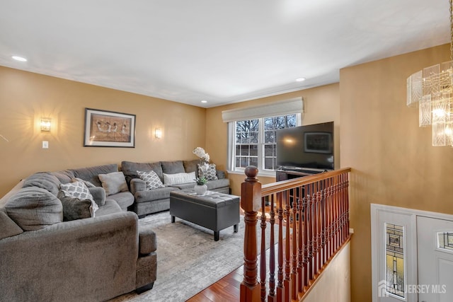 living room featuring recessed lighting, a notable chandelier, and wood finished floors
