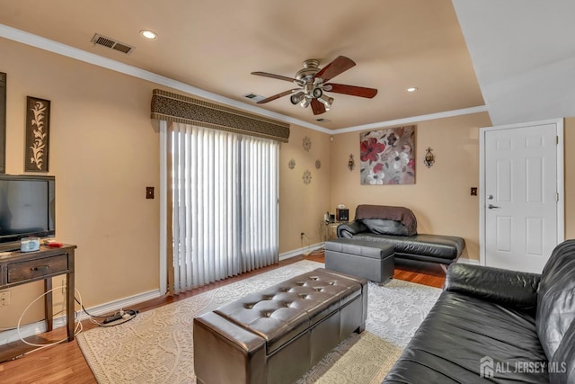 living room featuring wood finished floors, visible vents, ceiling fan, and baseboards